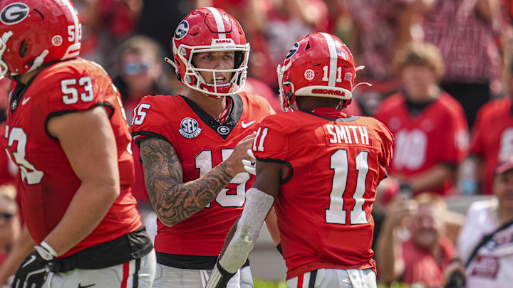 Sep 7, 2024; Athens, Georgia, USA; Georgia Bulldogs wide receiver Arian Smith (11) reacts with quarterback Carson Beck (15) after they combined on a touchdown pass against the Tennessee Tech Golden Eagles during the second half at Sanford Stadium. Mandatory Credit: Dale Zanine-Imagn Images