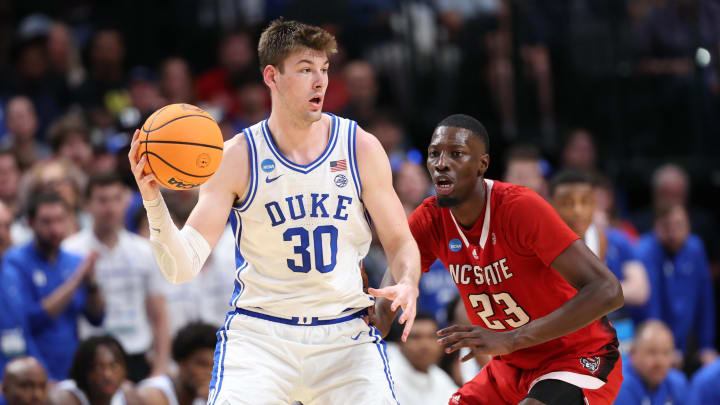 Mar 31, 2024; Dallas, TX, USA; Duke Blue Devils center Kyle Filipowski (30) controls the ball against North Carolina State Wolfpack forward Mohamed Diarra (23) in the second half in the finals of the South Regional of the 2024 NCAA Tournament at American Airline Center. Mandatory Credit: Kevin Jairaj-USA TODAY Sports