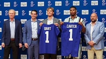 Apr 25, 2025; East Rutherford, NJ, US; New York Giants president John Mara (far left), general manager Joe Schoen (left), Jaxson Dart, Abdul Carter, and head coach Brian Daboll (right) pose for photos prior to the start of the press conference to introduce the Giants first round draft picks.   