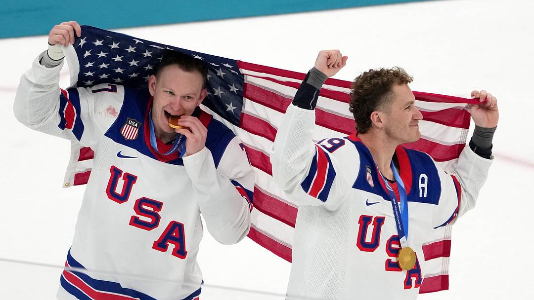Feb 22, 2026; Milan, Italy; Brady Tkachuk and Matthew Tkachuk of the United States celebrate after winning the men's ice hockey gold medal game during the Milano Cortina 2026 Olympic Winter Games at Milano Santagiulia Ice Hockey Arena. Mandatory Credit: James Lang-Imagn Images