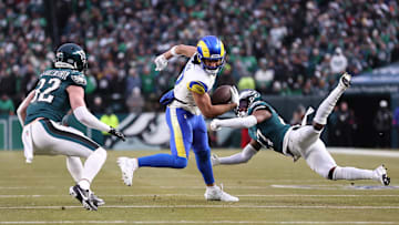 Jan 19, 2025; Philadelphia, Pennsylvania, USA; Los Angeles Rams wide receiver Puka Nacua (17) intercepts a pass in front of Philadelphia Eagles safety Reed Blankenship (32) and Eagles cornerback Quinyon Mitchell (27) during the first half in a 2025 NFC divisional round game at Lincoln Financial Field. Mandatory Credit: Bill Streicher-Imagn Images