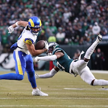 Jan 19, 2025; Philadelphia, Pennsylvania, USA; Los Angeles Rams wide receiver Puka Nacua (17) intercepts a pass in front of Philadelphia Eagles safety Reed Blankenship (32) and Eagles cornerback Quinyon Mitchell (27) during the first half in a 2025 NFC divisional round game at Lincoln Financial Field. Mandatory Credit: Bill Streicher-Imagn Images