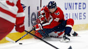 Mar 18, 2025; Washington, District of Columbia, USA; Washington Capitals center Lars Eller (20) checks Detroit Red Wings defenseman Erik Gustafsson (56) while going for the puck during the third period at Capital One Arena. Mandatory Credit: Peter Casey-Imagn Images