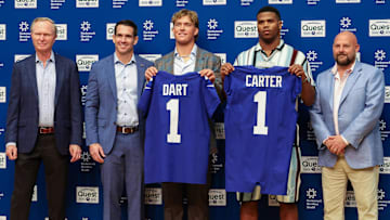Apr 25, 2025; East Rutherford, NJ, US; New York Giants president John Mara (far left), general manager Joe Schoen (left), Jaxson Dart, Abdul Carter, and head coach Brian Daboll (right) pose for photos prior to the start of the press conference to introduce the Giants first round draft picks.  Mandatory Credit: Thomas Salus-Imagn Images