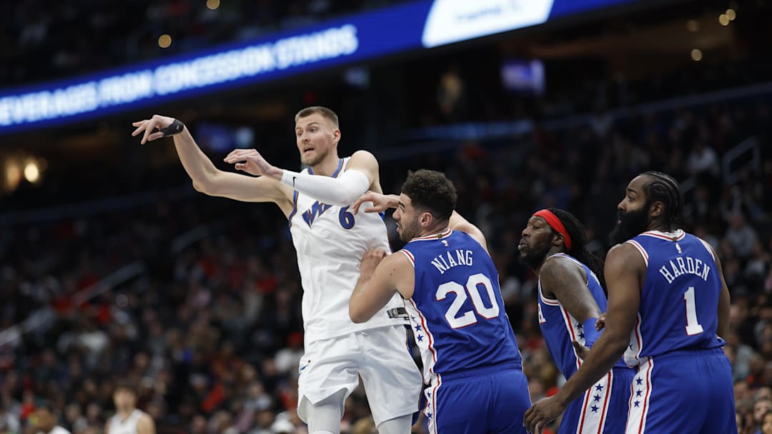 Dec 27, 2022; Washington, District of Columbia, USA; Washington Wizards center Kristaps Porzingis (6) passes the ball as Philadelphia 76ers forward Georges Niang (20) defends in the third quarter at Capital One Arena. Mandatory Credit: Geoff Burke-Imagn Images