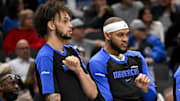 Dec 23, 2024; Dallas, Texas, USA; Dallas Mavericks center Dereck Lively II (left) and center Daniel Gafford (center) and guard Quentin Grimes (right) celebrate on the team bench during the second half against the Portland Trail Blazers at the American Airlines Center. Mandatory Credit: Jerome Miron-Imagn Images