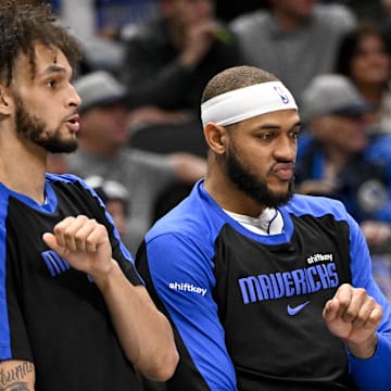 Dec 23, 2024; Dallas, Texas, USA; Dallas Mavericks center Dereck Lively II (left) and center Daniel Gafford (center) and guard Quentin Grimes (right) celebrate on the team bench during the second half against the Portland Trail Blazers at the American Airlines Center. Mandatory Credit: Jerome Miron-Imagn Images