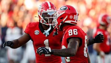 Georgia wide receiver Dillon Bell (86) celebrates with Georgia running back Trevor Etienne (1) after scoring a touchdown during the second half of a NCAA college football game against Auburn in Athens, Ga., on Saturday, Oct. 5, 2024.