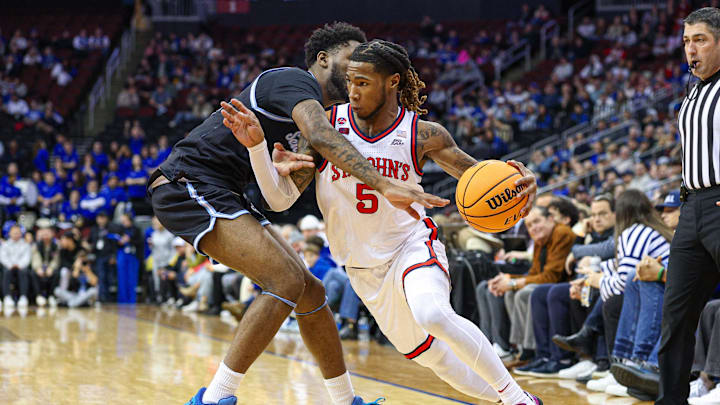 Jan 18, 2025; Newark, New Jersey, USA; St. John's basketball guard Deivon Smith (5) dribbles against Seton Hall Pirates guard Jahseem Felton (15) during the first half at Prudential Center.