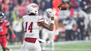 Dec 1, 2023; Lynchburg, VA, USA; New Mexico State Aggies wide receiver Trent Hudson (14) catches a touchdown pass against the Liberty Flames during the fourth quarter at Williams Stadium. Mandatory Credit: Brian Bishop-Imagn Images