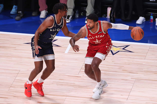 New Philadelphia 76ers forward Paul George dribbles past Tyrese Maxey during the 2024 NBA All-Star game in Indianapolis.