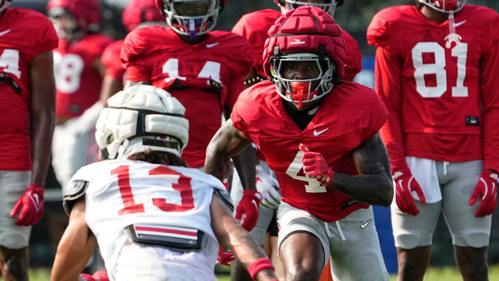 Aug 8, 2024; Columbus, Ohio, USA; Ohio State Buckeyes wide receiver Jeremiah Smith (4) lines up across from cornerback Miles Lockhart (13) during football practice at the Woody Hayes Athletic Complex.