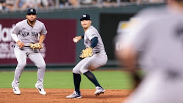 Jun 11, 2025; Kansas City, Missouri, USA; New York Yankees second base DJ LeMahieu (26) throws to first base during the eighth inning against the Kansas City Royals  at Kauffman Stadium. Mandatory Credit: William Purnell-Imagn Images