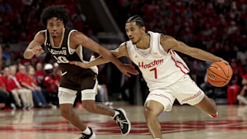 Houston Cougars guard Milos Uzan (7) drives against Lehigh Mountain Hawks guard Caleb Thomas (10) during the first half at Fertitta Center.