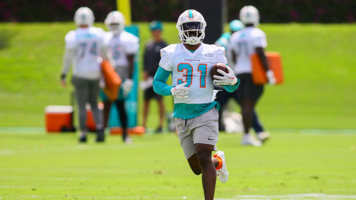 Jun 4, 2024; Miami Gardens, FL, USA; Miami Dolphins running back Raheem Mostert (31) runs with the football during mandatory minicamp at Baptist Health Training Complex. 