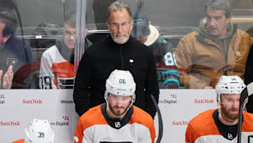 Dec 31, 2024; San Jose, California, USA; Philadelphia Flyers head coach John Tortorella watches game play against the San Jose Sharks with right wing Matvei Michkov (39), left wing Joel Farabee (86) and center Sean Couturier (14) during the third period at SAP Center at San Jose.