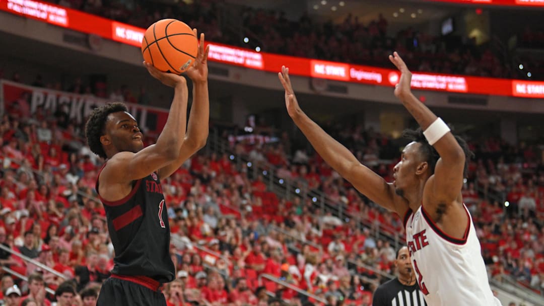 Mar 7, 2026; Raleigh, North Carolina, USA;  Stanford Cardinal guard Ebuka Okorie (1) shoots the ball against NC State Wolfpack guard Paul McNeil Jr. (2) during the second half at Lenovo Center. Mandatory Credit: Zachary Taft-Imagn Images