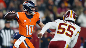 Nov 30, 2025; Landover, Maryland, USA; Denver Broncos quarterback Bo Nix (10) passes the ball under pressure from Washington Commanders defensive end Jacob Martin (55) in the first quarter of the game at Northwest Stadium. Mandatory Credit: Peter Casey-Imagn Images