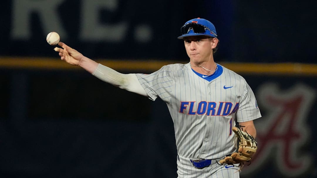 May 21, 2025; Hoover, AL, USA; Florida second baseman Justin Nadeau (1) fields and throws to first for an out during the game with Ole Miss in the second round of the SEC Baseball Tournament at the Hoover Met.