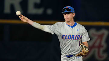 May 21, 2025; Hoover, AL, USA; Florida second baseman Justin Nadeau (1) fields and throws to first for an out during the game with Ole Miss in the second round of the SEC Baseball Tournament at the Hoover Met.