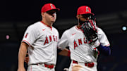 Apr 23, 2024; Anaheim, California, USA; Los Angeles Angels right fielder Jo Adell (7) meets with center fielder Mike Trout (27) following the top of the seventh inning against the Baltimore Orioles at Angel Stadium. Mandatory Credit: Gary A. Vasquez-Imagn Images