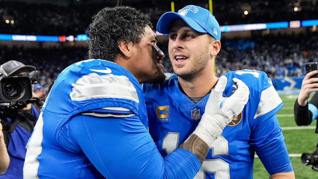 Detroit Lions offensive tackle Penei Sewell (58), left, talks to quarterback Jared Goff (16) after 23-20 win over Chicago Bears at Ford Field in Detroit on Thursday, Nov. 28, 2024.