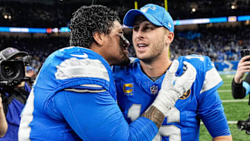 Detroit Lions offensive tackle Penei Sewell (58), left, talks to quarterback Jared Goff (16) after 23-20 win over Chicago Bears at Ford Field in Detroit on Thursday, Nov. 28, 2024.