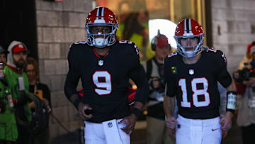 Atlanta Falcons quarterback Michael Penix Jr. and quarterback Kirk Cousins run on the field before a game against the New York Giants at Mercedes-Benz Stadium. 