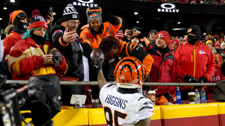 Cincinnati Bengals wide receiver Tee Higgins (85) hands his mother, Lady Stewart, a football after scoring a touchdown in the third quarter during the AFC championship NFL game between the Cincinnati Bengals and the Kansas City Chiefs, Sunday, Jan. 29, 2023, at GEHA Field at Arrowhead Stadium in Kansas City, Mo. The Kansas City Chiefs won, 23-20.

Cincinnati Bengals At Kansas City Chiefs Afc Championship Jan 29 0386