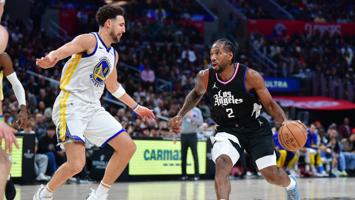 Dec 2, 2023; Los Angeles, California, USA; Los Angeles Clippers forward Kawhi Leonard (2) moves the ball against Golden State Warriors guard Klay Thompson (11) during the second half at Crypto.com Arena. Mandatory Credit: Gary A. Vasquez-USA TODAY Sports