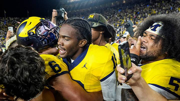 Michigan quarterback Bryce Underwood (19) hugs wide receiver JJ Buchanan (6), left, and defensive tackle Deyvid Palepale (54) after 13-12 win over Western Michigan at Michigan Stadium in Ann Arbor on Saturday, Sept. 5, 2026.