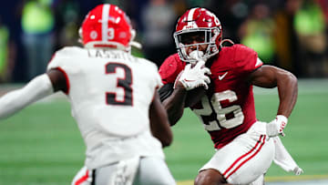 Dec 2, 2023; Atlanta, GA, USA;  Alabama Crimson Tide running back Jam Miller (26) runs against Georgia Bulldogs defensive back Kamari Lassiter (3) in the fourth quarter of the SEC Championship at Mercedes-Benz Stadium. Mandatory Credit: John David Mercer-USA TODAY Sports