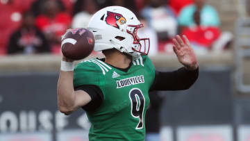Louisville’s Tyler Shough throws a touchdown pass to Chris Bell against Louisville’s defense Friday night at L&N Stadium.