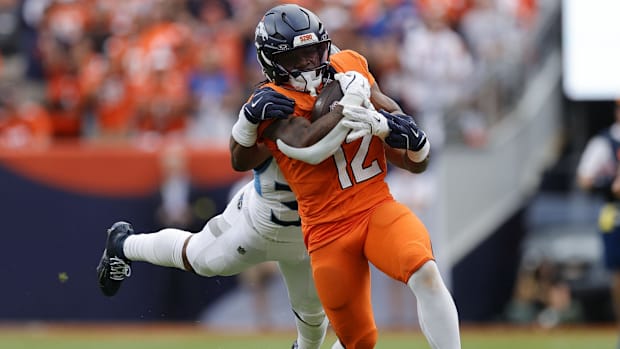 Denver Broncos running back RJ Harvey (12) rushes the ball against the Tennessee Titans.