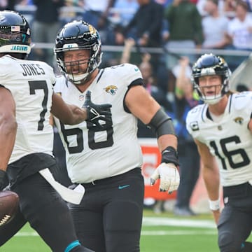 Oct 8, 2023; London, United Kingdom; Jacksonville Jaguars wide receiver Zay Jones (7) celebrates with guard Brandon Scherff (68) and quarterback Trevor Lawrence (16) after he scored a touchdown during the first half of an NFL International Series game at Tottenham Hotspur Stadium. Mandatory Credit: Peter van den Berg-Imagn Images