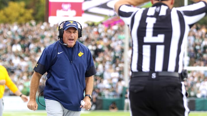 Sep 6, 2025; Athens, Ohio, USA; West Virginia Mountaineers head coach Rich Rodriguez calls a timeout during the second quarter against the Ohio Bobcats at Peden Stadium. Mandatory Credit: Ben Queen-Imagn Images