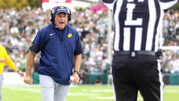 Sep 6, 2025; Athens, Ohio, USA; West Virginia Mountaineers head coach Rich Rodriguez calls a timeout during the second quarter against the Ohio Bobcats at Peden Stadium. Mandatory Credit: Ben Queen-Imagn Images