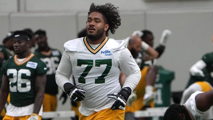 Jun 11, 2024; Green Bay, WI, USA; Green Bay Packers offensive tackle Jordan Morgan (77) exercises during minicamp