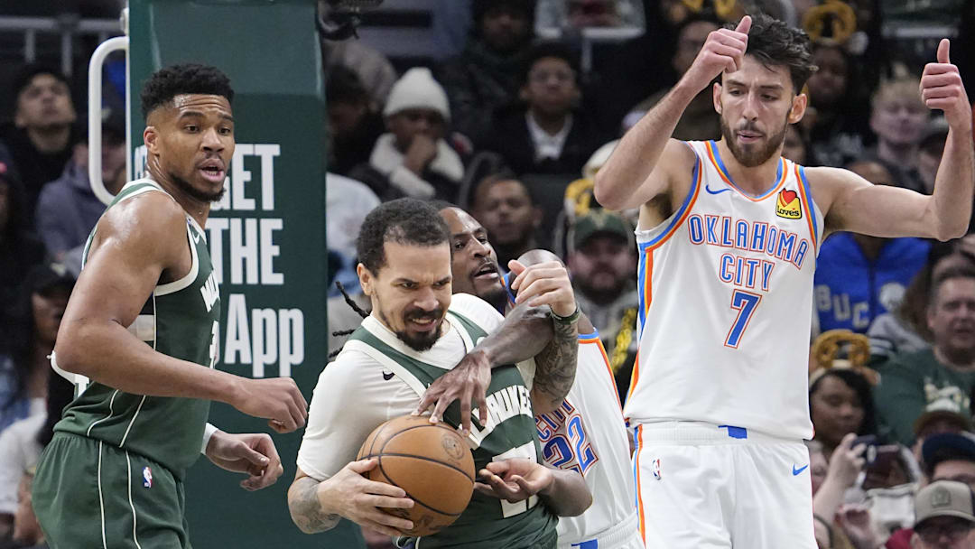 Jan 21, 2026; Milwaukee, Wisconsin, USA; Oklahoma City Thunder guard Cason Wallace (22) and Milwaukee Bucks guard Cole Anthony (50) battle for the ball in the first half at Fiserv Forum. Mandatory Credit: Michael McLoone-Imagn Images