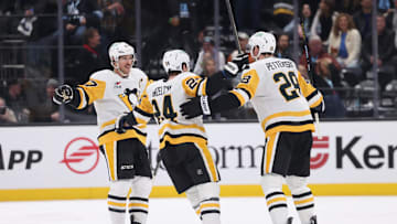 Jan 29, 2025; Salt Lake City, Utah, USA; Pittsburgh Penguins defenseman Marcus Pettersson (28) celebrates scoring a goal with defenseman Matt Grzelcyk (24) and center Sidney Crosby (87) during the second period at Delta Center. Mandatory Credit: Rob Gray-Imagn Images