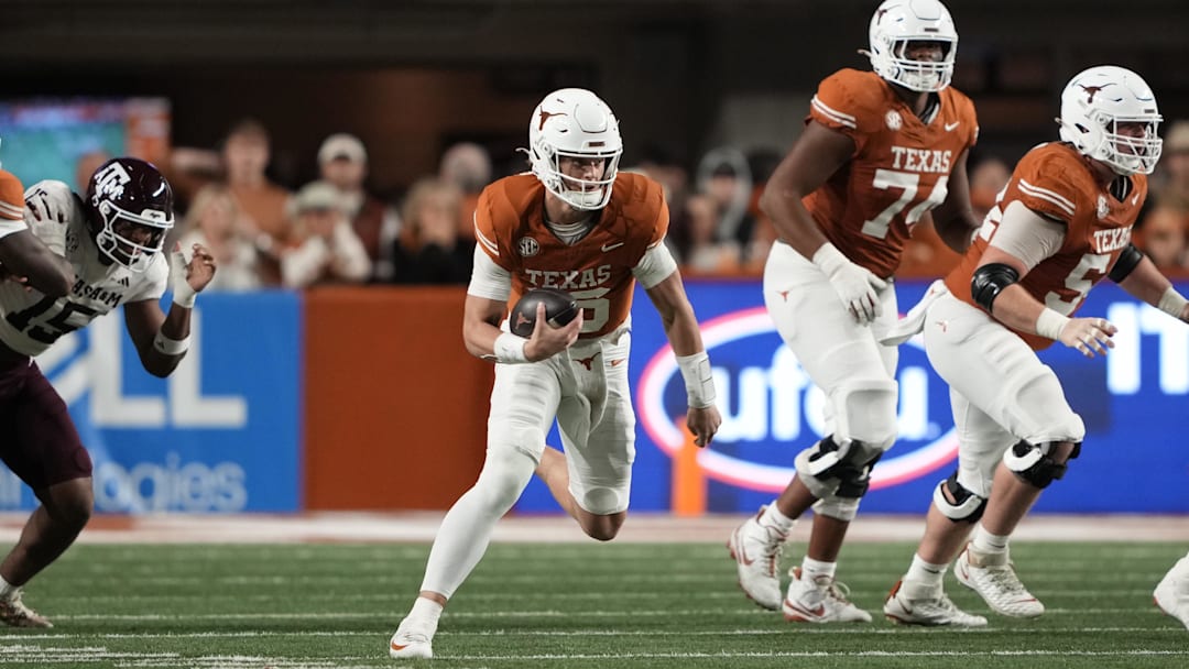 Nov 28, 2025; Austin, Texas, USA; Texas Longhorns quarterback Arch Manning keeps the ball for yardage during the first half against the Texas A&M Aggies at Darrell K Royal-Texas Memorial Stadium. Mandatory Credit: Scott Wachter-Imagn Images