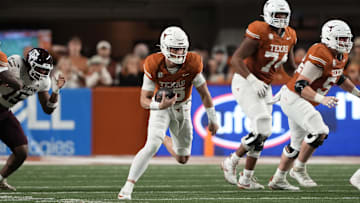 Nov 28, 2025; Austin, Texas, USA; Texas Longhorns quarterback Arch Manning keeps the ball for yardage during the first half against the Texas A&M Aggies at Darrell K Royal-Texas Memorial Stadium. Mandatory Credit: Scott Wachter-Imagn Images