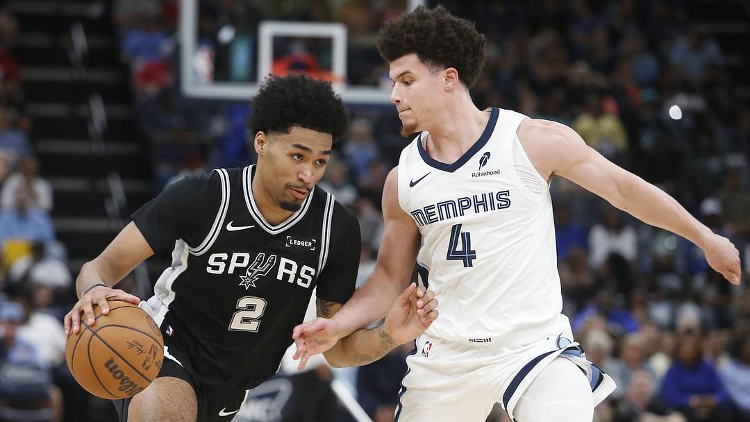 Mar 25, 2026; Memphis, Tennessee, USA; San Antonio Spurs guard Dylan Harper (2) drives to the basket as Memphis Grizzlies guard Walter Clayton Jr. (4) defends during the second quarter at FedExForum. Mandatory Credit: Petre Thomas-Imagn Images