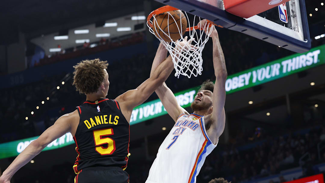 Oct 27, 2024; Oklahoma City, Oklahoma, USA; Oklahoma City Thunder center Chet Holmgren (7) dunks in front of Atlanta Hawks guard Dyson Daniels (5) during the second half at Paycom Center. Mandatory Credit: Alonzo Adams-Imagn Images