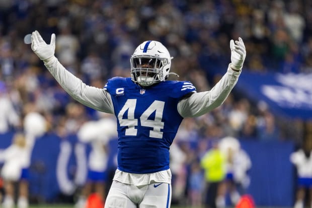 Football player Zaire Franklin pumps up the crowd in a blue jersey.