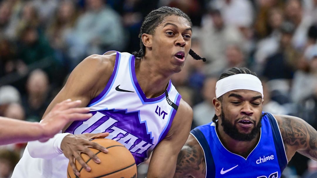Oct 13, 2025; Salt Lake City, Utah, USA; Utah Jazz forward Cody Williams (5) drives towards the center against Dallas Mavericks guard Jaden Hardy (1) during the second half at Delta Center. Mandatory Credit: Peter Creveling-Imagn Images