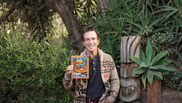Jeff Probst with the Survivor: The Tribe Has Spoken card game - Credit: Exploding Kittens 