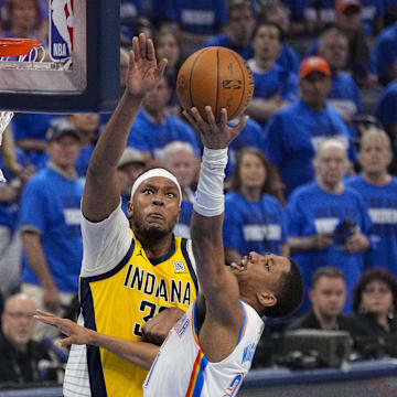 Jun 16, 2025; Oklahoma City, Oklahoma, USA; Oklahoma City Thunder guard Aaron Wiggins (21) drives to the basket past Indiana Pacers center Myles Turner (33) during the second quarter in game five of the 2025 NBA Finals at Paycom Center. Mandatory Credit: Kyle Terada-Imagn Images