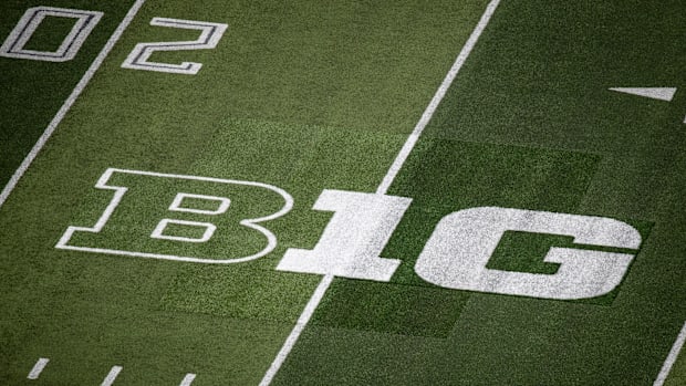A patchwork of turf surrounds the Big Ten logo where it replaced the Pac-12 logo on the field at Autzen Stadium