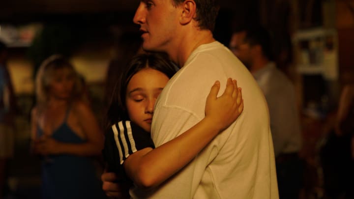 Paul Mescal as Calum and Frankie Corio as Sophie in Charlotte Wells' film Aftersun, embracing in one of the final scenes.